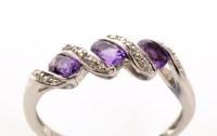 Lot 958 - An amethyst and diamond ring, the three oval...