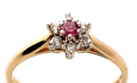 Lot 964 - A ruby and diamond star pattern ring, the...