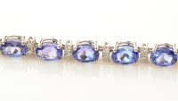 Lot 981 - A tanzanite and diamond bracelet, set with...