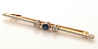 Lot 987 - A sapphire and diamond bar brooch, the central...