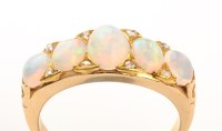 Lot 989 - An opal and diamond ring, the five oval...