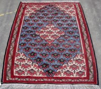 Lot 1234 - A Senneh Kilim rug, with stylized floral...