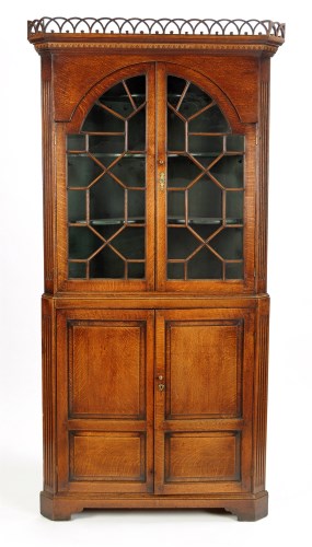 Lot 1318 - A George III oak standing corner cabinet, with...
