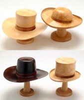Lot 45 - Andrew Hall: four hats on stands, one coloured,...