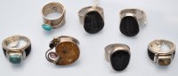 Lot 1089 - A fossil set ring; together with three other...