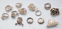 Lot 1090 - Thirteen silver rings of various designs.