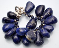 Lot 1104 - Hoorieh Coish: a lapis lazuli bangle, in...
