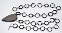 Lot 1107 - Hoorieh Coish: an agate and onyx necklace, the...