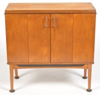Lot 1133 - A 1980's teak drinks cabinet, the hinged doors...
