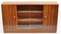Lot 1134 - A 1980's teak display side cabinet, the glazed...
