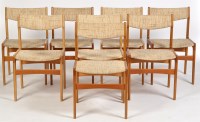 Lot 1140 - A set of eight 1980's teak dining chairs, the...