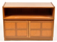 Lot 1143 - Parker Knoll: a teak cabinet, the top above an...