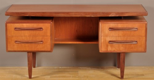 Lot 1155 - G-Plan: a teak desk, the rectangular top above...