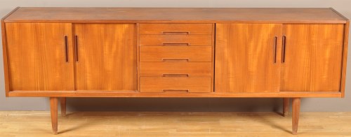 Lot 1182 - A 1970's teak sideboard, fitted five central...