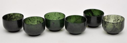 Lot 66 - Six small Chinese green hard stone bowls,...