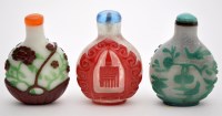Lot 73 - Three Chinese overlay glass snuff bottles and...