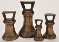 Lot 289 - A set of four George III bronze bell weights,...