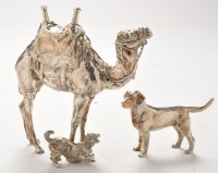 Lot 395 - A white metal ornament of a camel and dog;...
