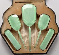 Lot 420 - A George V silver and green enamel five-piece...