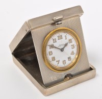 Lot 551 - A George V silver travel clock, by William...