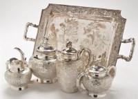 Lot 570 - An Asian white metal four-piece tea service...