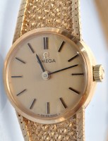 Lot 626 - Omega: a lady's 9ct. gold wristwatch and strap,...