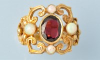 Lot 640 - A garnet, opal and 9ct. yellow gold dress ring,...