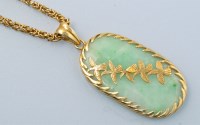 Lot 646 - A Chinese jade and yellow metal pendant, the...