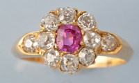 Lot 651 - A ruby and diamond cluster ring, the central...