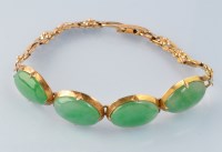 Lot 658 - A jadeite and yellow metal bracelet, the four...