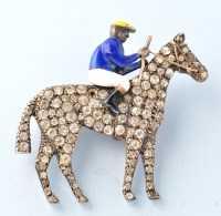 Lot 663 - A paste and enamel jockey brooch, the jockey...