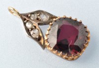 Lot 664 - A garnet and diamond pendant, the circular...