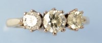 Lot 679 - A three stone diamond ring, the graduated...