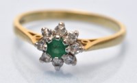 Lot 680 - An emerald and diamond cluster ring, the...