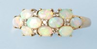 Lot 690 - An opal and diamond set dress ring, on 9ct....