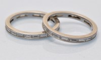 Lot 698 - A pair of diamond eternity rings, set...