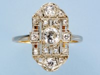Lot 700 - An Art Deco diamond ring, the central...