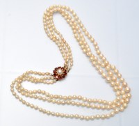 Lot 701 - A triple row graduated cultured pearl necklace,...