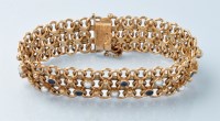 Lot 726 - A sapphire and half pearl set 9ct. yellow gold...