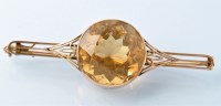 Lot 730 - A citrine and yellow metal brooch, the central...