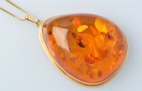 Lot 734 - An amber drop pendant, the pear-shaped...