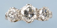 Lot 745 - A three stone diamond ring, the central...