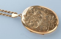 Lot 748 - A 9ct. yellow gold oval locket pendant, the...