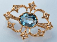 Lot 756 - A blue topaz and diamond brooch, the oval...