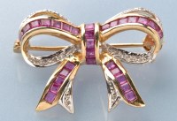 Lot 757 - A ruby and diamond bow pattern brooch, set...