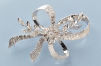 Lot 758 - A diamond and 18ct. white gold bow and floral...