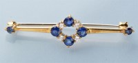 Lot 762 - A sapphire and diamond bar brooch, the central...