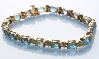 Lot 768 - A topaz and 9ct. yellow gold bracelet,...