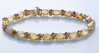 Lot 769 - An opal and 9ct. yellow gold bracelet,...