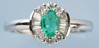 Lot 773 - An emerald and diamond cluster ring, the oval...